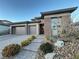 Modern two-story home with a three-car garage and landscaped front yard at 12422 Tudor Arch Dr, Las Vegas, NV 89138