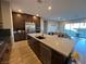 Modern kitchen with large island and Gathering room view at 12422 Tudor Arch Dr, Las Vegas, NV 89138