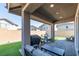 Covered patio with seating area, artificial turf, and built-in grill at 126 Ostinato Ln, Henderson, NV 89015