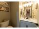 Clean and modern powder room with single sink vanity and mirrored medicine cabinet at 126 Ostinato Ln, Henderson, NV 89015