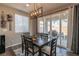 Bright dining room with dark wood table and access to backyard patio at 126 Ostinato Ln, Henderson, NV 89015