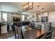 Open concept dining area with dark wood table and views into living room at 126 Ostinato Ln, Henderson, NV 89015