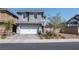 Two-story house with gray exterior, white garage door, and landscaped front yard at 126 Ostinato Ln, Henderson, NV 89015