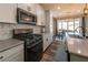 Modern kitchen with white cabinets, gray countertops, and stainless steel appliances at 126 Ostinato Ln, Henderson, NV 89015