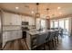 Modern kitchen with white cabinets, gray countertops, and stainless steel appliances at 126 Ostinato Ln, Henderson, NV 89015