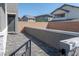 Small paved patio area with brick wall and black metal gate at 126 Ostinato Ln, Henderson, NV 89015