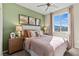 Bedroom with green accent wall, queen bed, and wood nightstands at 127 Harmonica Ave # Lot 14, Henderson, NV 89011