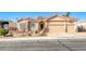 Tan two-story house with a three-car garage and desert landscaping at 1426 Radig Ct, Boulder City, NV 89005