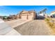 Tan house with two-car garage and RV parking at 1426 Radig Ct, Boulder City, NV 89005