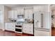 Modern kitchen with white cabinets, granite counters, and stainless steel appliances at 1426 Radig Ct, Boulder City, NV 89005