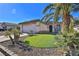 Single-story house with a landscaped front yard, two-car garage, and palm trees at 167 White Butte St, Henderson, NV 89012