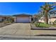 House exterior showcasing a two-car garage and desert landscaping at 167 White Butte St, Henderson, NV 89012