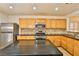 Kitchen with wood cabinets, granite countertops, and stainless steel appliances at 167 White Butte St, Henderson, NV 89012