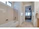 Bathroom features a bathtub, shower, and a view into the bedroom at 1848 Mountain Ranch Ave, Henderson, NV 89012