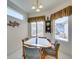 Cozy dining area with a small table and chairs, offering views of the backyard at 1848 Mountain Ranch Ave, Henderson, NV 89012