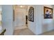 Bright entryway with tiled floor, neutral walls and decorative wall art at 1848 Mountain Ranch Ave, Henderson, NV 89012