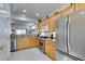 Modern kitchen with stainless steel appliances and light wood cabinets at 1848 Mountain Ranch Ave, Henderson, NV 89012