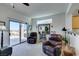 Living area with sliding glass doors, comfortable seating, and a view at 1848 Mountain Ranch Ave Dr, Henderson, NV 89012