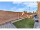 Artificial turf backyard with patio, dining set and string lights at 1992 Star Creek Bay Ln, Las Vegas, NV 89115