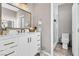 Modern bathroom with white vanity, gold accents, and walk-in shower at 1992 Star Creek Bay Ln, Las Vegas, NV 89115