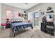 Bedroom with a metal bed frame, vanity, and balcony access at 1992 Star Creek Bay Ln, Las Vegas, NV 89115