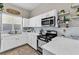 Modern white kitchen with stainless steel appliances and quartz countertops at 1992 Star Creek Bay Ln, Las Vegas, NV 89115