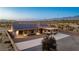 Aerial view of house with solar panels, large backyard and a covered patio at 2051 Saginaw Ave, Pahrump, NV 89048