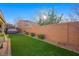 Artificial turf backyard with a brick wall and landscaping at 2365 Boretto St, Henderson, NV 89044