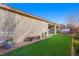 Large backyard with artificial turf and a modern bench at 2365 Boretto St, Henderson, NV 89044