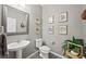 Modern bathroom with pedestal sink, toilet and decorative wall art at 2365 Boretto St, Henderson, NV 89044