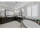 Large bathroom with double vanity, corner bathtub and a chandelier at 2365 Boretto St, Henderson, NV 89044