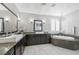 Elegant bathroom with double vanity, soaking tub and chandelier at 2365 Boretto St, Henderson, NV 89044