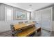 Bright dining room with wood table, bench, and white plantation shutters at 2365 Boretto St, Henderson, NV 89044