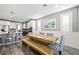 Open concept dining room with rustic wood table and modern chairs at 2365 Boretto St, Henderson, NV 89044