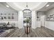 Inviting foyer with elegant wood flooring, a stylish light fixture, and decorative wall paneling at 2365 Boretto St, Henderson, NV 89044