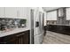 Sleek kitchen with stainless steel refrigerator and dark cabinets at 2365 Boretto St, Henderson, NV 89044