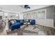 Stylish living room featuring a large sectional sofa, unique ceiling fan, and bright windows with shutters at 2365 Boretto St, Henderson, NV 89044