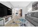 Open living room featuring a gray couch and a view into the kitchen at 4200 S Valley View Blvd # 1083, Las Vegas, NV 89103