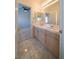 Bathroom boasts double vanity and updated light fixtures at 4654 Stuttgart St, Las Vegas, NV 89147