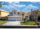 Two-story house with a three-car garage and manicured lawn at 4654 Stuttgart St, Las Vegas, NV 89147