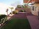 Landscaped backyard with patio and artificial turf at 4694 E Lucera Ct, Pahrump, NV 89061