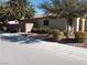 Tan house with tile roof, landscaped yard, and a block wall for privacy at 4694 E Lucera Ct, Pahrump, NV 89061