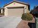 Attached two-car garage with tan doors at 4694 E Lucera Ct, Pahrump, NV 89061