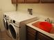 Laundry room with utility sink and ample storage at 4694 E Lucera Ct, Pahrump, NV 89061