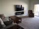 Living room features a fireplace, large TV, and comfortable seating at 4694 E Lucera Ct, Pahrump, NV 89061