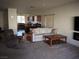 Open living room, view of kitchen and fireplace at 4694 E Lucera Ct, Pahrump, NV 89061