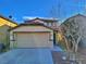 Two-story house with beige exterior, attached garage, and landscaping at 4823 Jubilee Diamond Ct, Las Vegas, NV 89139