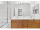 Double sink bathroom with shower and tub, wood cabinets and mirrors at 5155 W Tropicana Ave # 2123, Las Vegas, NV 89103