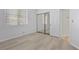 Spacious bedroom with mirrored closet doors and large window at 5155 W Tropicana Ave # 2123, Las Vegas, NV 89103