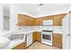 Modern kitchen with white appliances and wood cabinets at 5155 W Tropicana Ave # 2123, Las Vegas, NV 89103